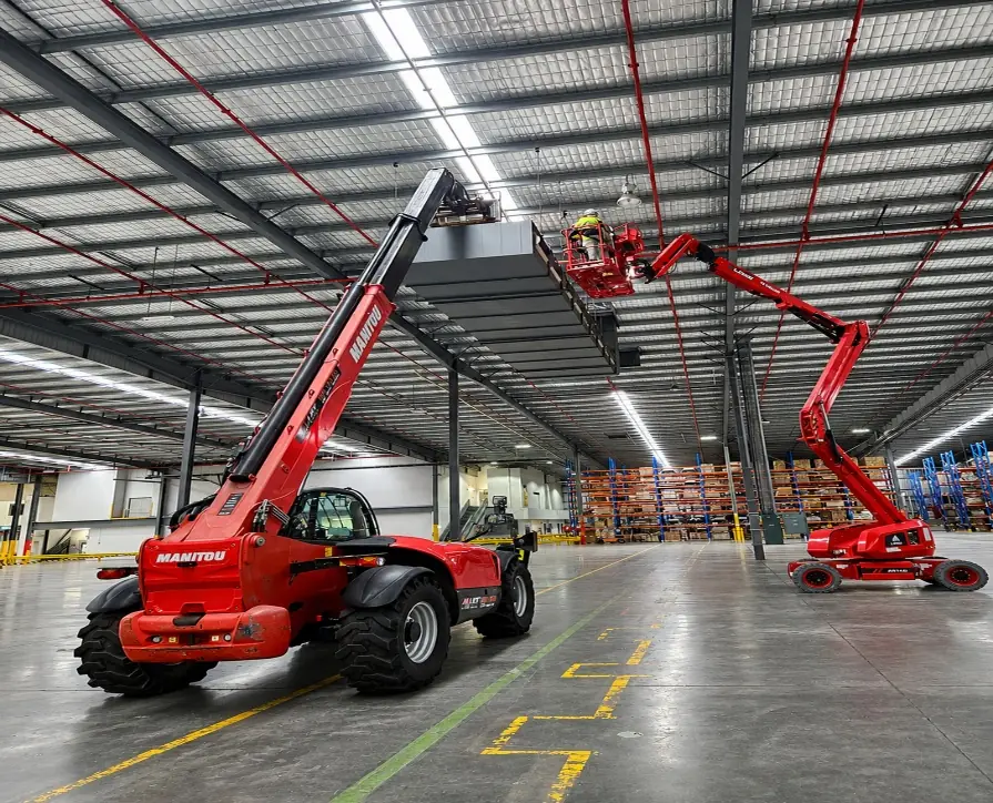 Manitou telehandler and boom lift dismantling warehouse ductwork
