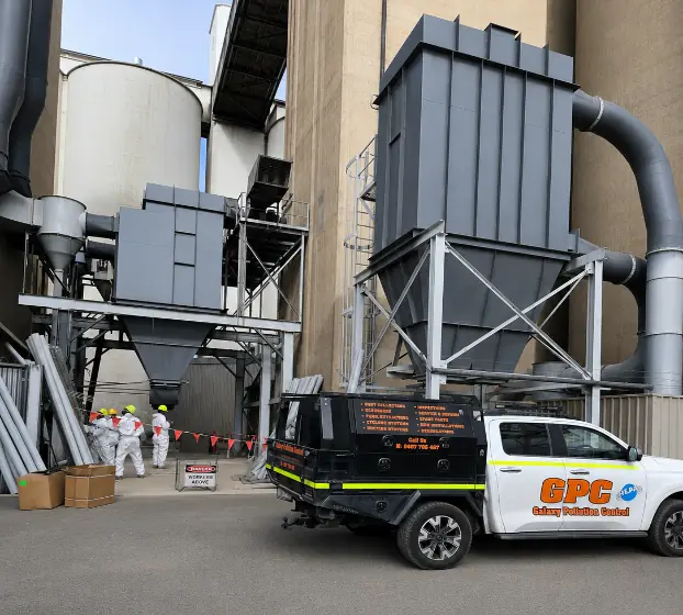 GPC service truck on industrial site with dust collectors and silos